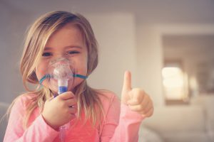 little girl with oxygen mask