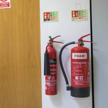 A foam and CO2 fire extinguisher on a wall