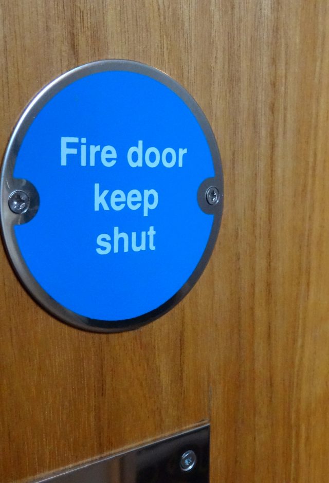 Image of circular blue Fire Door Keep Shut safety sign